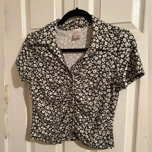 A green crop top shirt with flowers